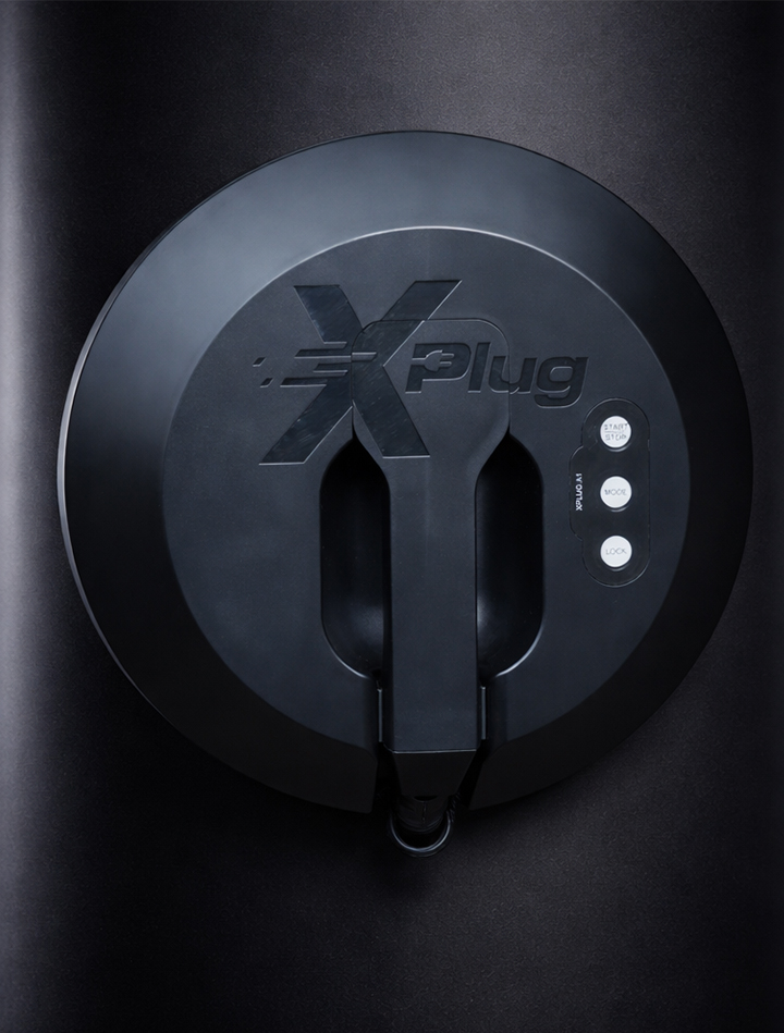 Man holding bike while standing on gray mountain